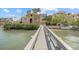 Waterfront home view from a private wooden dock with lush greenery at 1364 Point Crisp Rd, Sarasota, FL 34242