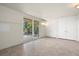 Bright room with tile flooring, sliding glass door access to outside, and multiple closet spaces for storage at 1364 Point Crisp Rd, Sarasota, FL 34242