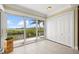 Bright sunroom with sliding glass doors, white closets, and tranquil water views; a perfect retreat at 1364 Point Crisp Rd, Sarasota, FL 34242