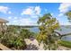 Expansive waterfront view with a lush, green landscape from a terrace at 1364 Point Crisp Rd, Sarasota, FL 34242