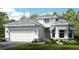 Charming single-story home showcasing a clean white exterior, gray roof, and a two-car garage at 14953 Contenta Loop, Bradenton, FL 34211