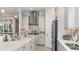 Stylish kitchen with stainless steel appliances, white cabinets, a large island, and a mosaic backsplash at 14953 Contenta Loop, Bradenton, FL 34211