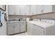 Well-equipped laundry room with modern appliances, ample storage, and a convenient sink area at 14953 Contenta Loop, Bradenton, FL 34211