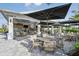 Inviting outdoor patio seating area with shaded tables and umbrellas, perfect for dining at 14953 Contenta Loop, Bradenton, FL 34211