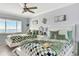 Comfortable bedroom with two beds, complemented by a view of the water at 1602 Stickney Point Rd # 404, Sarasota, FL 34231