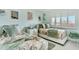 Comfortable bedroom with two beds, complemented by a view of the window at 1602 Stickney Point Rd # 404, Sarasota, FL 34231