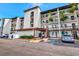 Exterior view of condo with covered parking and lush landscaping near entrance at 1602 Stickney Point Rd # 404, Sarasota, FL 34231