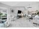 Expansive living room with stylish decor, tv, adjacent kitchen, and lots of natural light at 1602 Stickney Point Rd # 404, Sarasota, FL 34231
