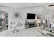 Living room area features high ceilings, tile floors, and neutral decor for a modern look at 1602 Stickney Point Rd # 404, Sarasota, FL 34231