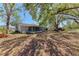 Expansive backyard with mature trees and a cozy screened porch, perfect for outdoor enjoyment at 1761 Shevlin St, North Port, FL 34286