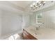Bathroom featuring white tile, a large vanity mirror, and a shower at 1761 Shevlin St, North Port, FL 34286