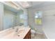 Bathroom featuring tiled walls, a large mirror, and natural light from the window at 1761 Shevlin St, North Port, FL 34286