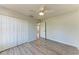 Bright bedroom features wood flooring, a ceiling fan, closet space, and a sunny window at 1761 Shevlin St, North Port, FL 34286