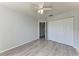 Bedroom featuring gray-wood laminate flooring, a ceiling fan, and a closet at 1761 Shevlin St, North Port, FL 34286