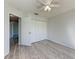 Bedroom with gray-wood laminate flooring, a ceiling fan, and large closet at 1761 Shevlin St, North Port, FL 34286