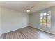 Comfortable bedroom with wood flooring, a ceiling fan, and a sunny window at 1761 Shevlin St, North Port, FL 34286