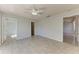 Bedroom featuring a ceiling fan, tiled floors, and multiple entrances at 1761 Shevlin St, North Port, FL 34286