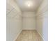 Walk-in closet featuring wire shelving and tile flooring at 1761 Shevlin St, North Port, FL 34286