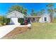 Charming single-story home featuring a well-maintained lawn and a quaint front porch entrance at 1761 Shevlin St, North Port, FL 34286