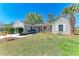 Inviting single-story home with a well-manicured lawn and a welcoming front porch area at 1761 Shevlin St, North Port, FL 34286