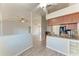Open kitchen and living room space with granite counters, wood cabinets, and modern appliances at 1761 Shevlin St, North Port, FL 34286