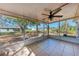 Relaxing screened porch with ceiling fan and tile flooring, perfect for enjoying the backyard view at 1761 Shevlin St, North Port, FL 34286