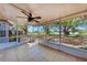 Screened porch with ceiling fan and tile flooring overlooking the backyard at 1761 Shevlin St, North Port, FL 34286