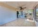 Inviting screened porch with a ceiling fan and direct access to the backyard at 1761 Shevlin St, North Port, FL 34286