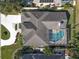 Aerial view of the house featuring a screened pool and well-maintained landscaping at 1817 91St Nw St, Bradenton, FL 34209