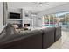 Comfortable living room with fireplace, large sectional couch, and sliding doors to the pool at 1817 91St Nw St, Bradenton, FL 34209