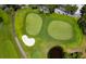 Stunning aerial shot of a golf course featuring perfectly manicured greens, bunkers, and lush landscaping at 1900 Harbourside Dr # 102, Longboat Key, FL 34228