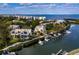 Stunning aerial view showcases waterfront residences with private boat docks and serene ocean backdrop at 1900 Harbourside Dr # 102, Longboat Key, FL 34228