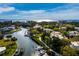 Scenic aerial view of waterfront homes with boat docks, canal access, and ocean skyline at 1900 Harbourside Dr # 102, Longboat Key, FL 34228