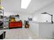 Spacious basement offering ample room for various activities, complete with a workbench and storage shelves at 1900 Harbourside Dr # 102, Longboat Key, FL 34228