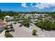 Aerial view of a well-maintained shopping center surrounded by trees, palm trees and parking areas at 1900 Harbourside Dr # 102, Longboat Key, FL 34228