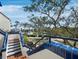 Staircase with blue tile accents, offering picturesque views of lush landscaping and a tranquil canal at 1900 Harbourside Dr # 102, Longboat Key, FL 34228
