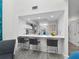 Modern kitchen features white cabinets, sleek countertops, and seating at the peninsula at 1900 Harbourside Dr # 102, Longboat Key, FL 34228