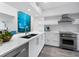 Bright kitchen featuring white cabinets, quartz counters, and stainless steel Wolf appliances at 1900 Harbourside Dr # 102, Longboat Key, FL 34228