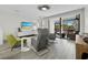 Cozy living room with sleek flooring, modern furniture, and a sliding door to the outdoors at 1900 Harbourside Dr # 102, Longboat Key, FL 34228