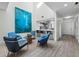 Open-concept living space featuring modern decor, sleek flooring, and a partial view of the kitchen at 1900 Harbourside Dr # 102, Longboat Key, FL 34228