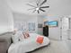 Comfortable main bedroom featuring tile floors, plantation shutters, and access to an ensuite bathroom at 1900 Harbourside Dr # 102, Longboat Key, FL 34228