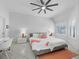 Serene main bedroom featuring neutral tones, tile floors, a large window, and a modern ceiling fan at 1900 Harbourside Dr # 102, Longboat Key, FL 34228
