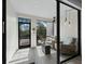 Enclosed patio with views of surrounding trees, comfortable seating, and modern lighting fixtures at 1900 Harbourside Dr # 102, Longboat Key, FL 34228