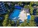 Aerial shot of community pool area surrounded by lush landscaping and amenities at 1900 Harbourside Dr # 102, Longboat Key, FL 34228