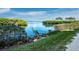 Beautiful tranquil view of the water surrounded by lush greenery at 1900 Harbourside Dr # 102, Longboat Key, FL 34228