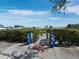 Picturesque waterfront entrance leading to the private boat dock and pool, framed by lush greenery and blue sky at 1900 Harbourside Dr # 102, Longboat Key, FL 34228