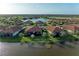 Aerial view showcasing waterfront homes nestled around a serene lake, highlighting a peaceful community setting at 24068 Canterwood Way, Venice, FL 34293