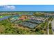 Wonderful aerial view showcases tennis courts, pool, and clubhouse in a lush, landscaped community at 24068 Canterwood Way, Venice, FL 34293