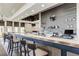 Stylish bar featuring elegant countertops, a well-stocked selection of beverages, and comfortable seating at 24068 Canterwood Way, Venice, FL 34293