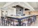Upscale bar area with stylish seating, elegant lighting, and a well-stocked display of beverages at 24068 Canterwood Way, Venice, FL 34293